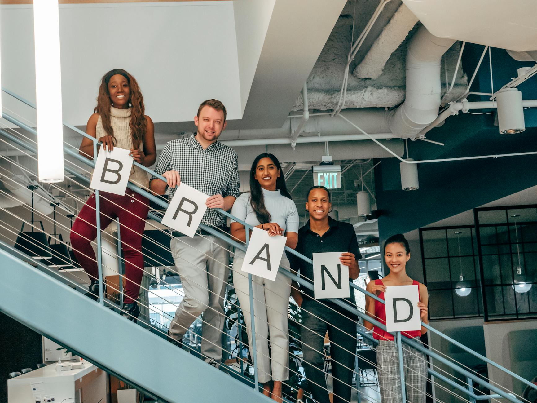 happy coworkers standing on a stairway